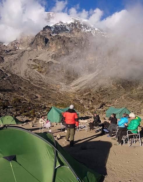 Hikers resting at Barranco Camp during an acclimatization day on Mount Kilimanjaro