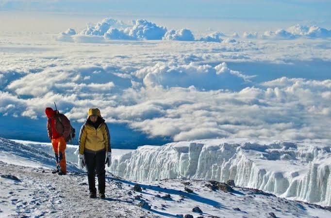 Hikers resting at Barranco Camp with views of the Barranco Wall