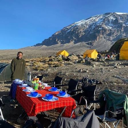 Hiking across alpine desert landscape towards Barafu Base Camp on Mount Kilimanjaro