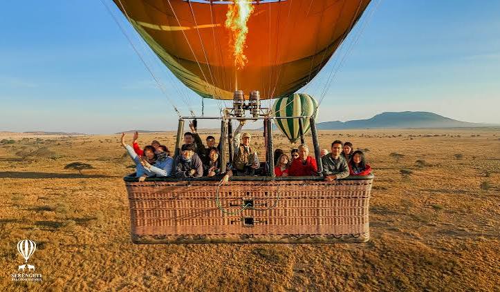 Hot Air Balloons Flying Over Serengeti National Park Plains at Sunrise