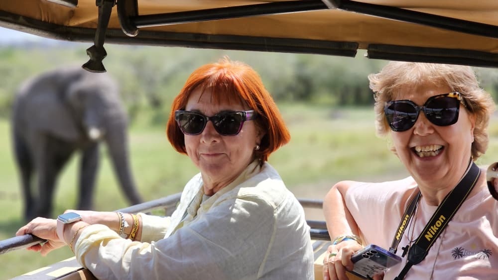 Tourists in a safari jeep spotting wildlife in Tanzania